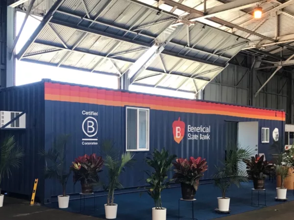 The exterior of the Beneficial State Bank Loan Production Office shipping container, with potted plants around it.