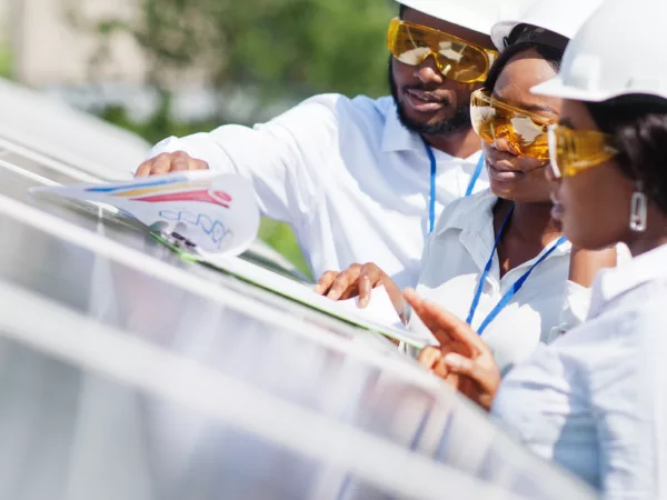 Three engineers working on solar panel installation